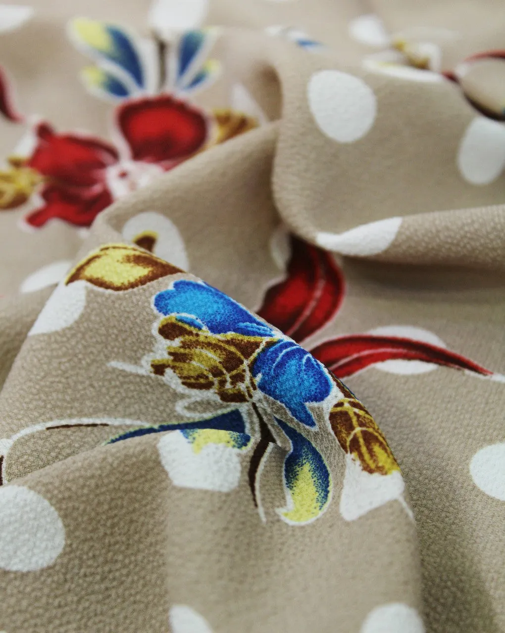 Polyester bubble crepe fabric in dark cream with multicolor floral print